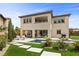 A modern house with a private backyard featuring a pool, spa, and artificial turf at 4220 San Alivia Ct, Las Vegas, NV 89141