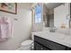 Bright bathroom featuring a vanity with a dark wood cabinet, white countertop, and a framed window at 4220 San Alivia Ct, Las Vegas, NV 89141