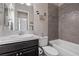 Modern bathroom featuring a tiled shower/tub, white countertops, and a dark wood vanity at 4220 San Alivia Ct, Las Vegas, NV 89141