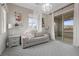 Comfortable bedroom featuring a cozy sofa under a canopy and a sliding glass door to a balcony at 4220 San Alivia Ct, Las Vegas, NV 89141