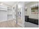 Bright walk-in closet featuring custom shelving, a mirrored door, and neutral decor providing ample storage at 4220 San Alivia Ct, Las Vegas, NV 89141