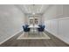 Bright dining room featuring a modern table set, wainscoting, and a decorative chandelier at 4220 San Alivia Ct, Las Vegas, NV 89141