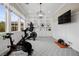 Bright exercise room with built-in shelving and two exercise bikes for a complete home workout space at 4220 San Alivia Ct, Las Vegas, NV 89141