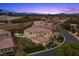 Serene community view featuring beautiful houses, desert landscaping and mountain views at dusk at 4220 San Alivia Ct, Las Vegas, NV 89141