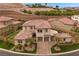Elegant two-story home featuring a well-maintained lawn, desert landscaping, and a circular driveway at 4220 San Alivia Ct, Las Vegas, NV 89141