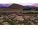 Serene community view featuring beautiful houses, desert landscaping and mountain views at 4220 San Alivia Ct, Las Vegas, NV 89141