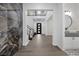 Stunning foyer with wood floors, grand staircase, decorative marble wall and modern accents at 4220 San Alivia Ct, Las Vegas, NV 89141