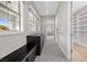 Hallway featuring a patterned carpet, dark wood storage, natural light, and access to a walk-in closet at 4220 San Alivia Ct, Las Vegas, NV 89141