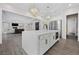 Open-concept kitchen featuring a large island, stainless steel appliances, and modern fixtures at 4220 San Alivia Ct, Las Vegas, NV 89141