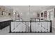 Upper landing with black and white banister overlooks a stone accent wall and built in cabinet space at 4220 San Alivia Ct, Las Vegas, NV 89141