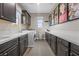 Well-equipped laundry room with a washer, dryer, cabinets, counterspace, and accent art at 4220 San Alivia Ct, Las Vegas, NV 89141