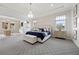 Comfortable main bedroom with elegant decor, complemented by a sitting area and natural light at 4220 San Alivia Ct, Las Vegas, NV 89141