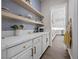 Butler's pantry with granite countertops, cabinetry and modern fixtures at 4220 San Alivia Ct, Las Vegas, NV 89141