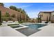 Resort-style pool area with a spa, waterfall feature, lounge seating, and lush landscaping at 4220 San Alivia Ct, Las Vegas, NV 89141