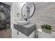 Elegant powder room with a vessel sink, textured wall, and a contrasting dark countertop at 4220 San Alivia Ct, Las Vegas, NV 89141
