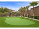 Backyard putting green with artificial turf, mature landscaping, and privacy walls offer recreation at 4220 San Alivia Ct, Las Vegas, NV 89141