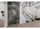 Elegant staircase with marble accents, hardwood floors and a contemporary design at 4220 San Alivia Ct, Las Vegas, NV 89141