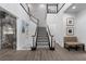 Elegant staircase with marble accents, hardwood floors and a contemporary design at 4220 San Alivia Ct, Las Vegas, NV 89141