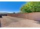 Expansive backyard featuring decorative rock, privacy wall and mature tree at 4260 Helena Cove Ct, Las Vegas, NV 89129