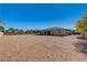 Expansive backyard featuring decorative rock, palm trees, privacy wall, and exterior view of home at 4260 Helena Cove Ct, Las Vegas, NV 89129