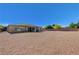 Expansive backyard featuring decorative rock, privacy wall, and exterior view of home at 4260 Helena Cove Ct, Las Vegas, NV 89129
