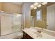 Traditional bathroom featuring a shower/tub combo, white marble countertop, and wood cabinetry at 4260 Helena Cove Ct, Las Vegas, NV 89129