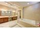 Luxurious primary bathroom with a soaking tub, walk-in shower, and vanity at 4260 Helena Cove Ct, Las Vegas, NV 89129