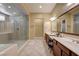 Spacious bathroom featuring a large walk-in shower, double vanity, and neutral tile flooring at 4260 Helena Cove Ct, Las Vegas, NV 89129