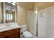 Bathroom featuring a glass-enclosed shower, spacious vanity, and good natural lighting at 4260 Helena Cove Ct, Las Vegas, NV 89129