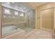 Bright bathroom showcasing a soaking tub and a frameless glass shower at 4260 Helena Cove Ct, Las Vegas, NV 89129