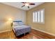 Cozy bedroom features a ceiling fan and white plantation shutters at 4260 Helena Cove Ct, Las Vegas, NV 89129