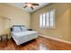 Cozy bedroom features hardwood floors, plantation shutters, and a ceiling fan for year-round comfort at 4260 Helena Cove Ct, Las Vegas, NV 89129