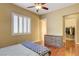 Cozy bedroom features wood floors, ceiling fan, and window with white shutters at 4260 Helena Cove Ct, Las Vegas, NV 89129