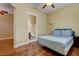 This bedroom has a view to the bathroom with its comfortable bed and hardwood floors at 4260 Helena Cove Ct, Las Vegas, NV 89129