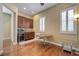 The bonus room offers a wet bar with sleek cabinets and a dining area near shuttered windows at 4260 Helena Cove Ct, Las Vegas, NV 89129