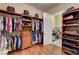 Spacious walk-in closet with custom shelving and a view of the adjacent laundry room at 4260 Helena Cove Ct, Las Vegas, NV 89129