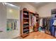 Well-organized walk-in closet featuring ample shelving and hanging space, with a view into the laundry room at 4260 Helena Cove Ct, Las Vegas, NV 89129