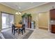 Bright dining area with chandelier, built-in hutch, and sliding glass door to patio at 4260 Helena Cove Ct, Las Vegas, NV 89129