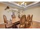 This dining room features hardwood floors, a decorative light, and tray ceilings at 4260 Helena Cove Ct, Las Vegas, NV 89129