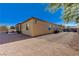 Exterior view of home and backyard featuring decorative rock, palm trees, and privacy wall at 4260 Helena Cove Ct, Las Vegas, NV 89129