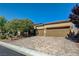 Attractive single-story home features three-car garage, desert landscaping, and long paver driveway at 4260 Helena Cove Ct, Las Vegas, NV 89129