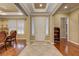 Elegant home foyer featuring tile and hardwood flooring, paneled doors, and neutral decor at 4260 Helena Cove Ct, Las Vegas, NV 89129