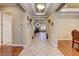 Inviting home foyer with tile flooring leading to hardwood, neutral walls, and decorative accents at 4260 Helena Cove Ct, Las Vegas, NV 89129