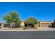 Beautiful single-story home featuring desert landscaping, a two car garage, and a mature shade tree at 4260 Helena Cove Ct, Las Vegas, NV 89129