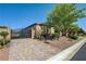 Single-story home boasts decorative iron gate, a paver driveway, and mature shade trees at 4260 Helena Cove Ct, Las Vegas, NV 89129