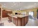 A gourmet kitchen boasts a large granite island and stainless appliances with an adjacent dining area and barstool seating at 4260 Helena Cove Ct, Las Vegas, NV 89129