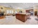 Open-concept kitchen featuring an island with granite countertop and stainless steel appliances adjacent to a cozy living room at 4260 Helena Cove Ct, Las Vegas, NV 89129