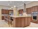 This expansive kitchen features an oversized island with a breakfast bar and modern stainless steel appliances and granite countertops at 4260 Helena Cove Ct, Las Vegas, NV 89129