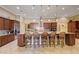 The gourmet kitchen has a large granite island and stainless appliances, with custom barstools for casual dining at 4260 Helena Cove Ct, Las Vegas, NV 89129