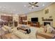 Open-concept living area featuring a fireplace, breakfast bar, and lots of natural light at 4260 Helena Cove Ct, Las Vegas, NV 89129